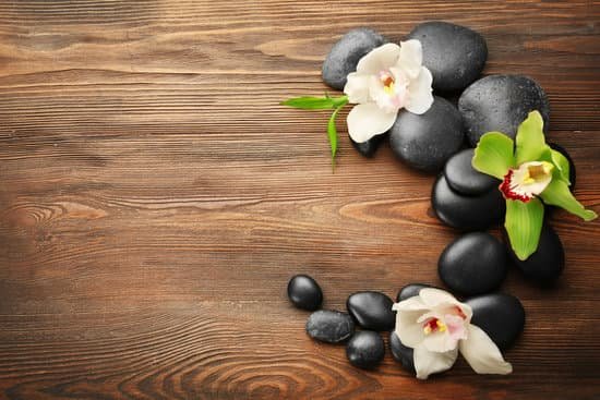 canva stones and orchids on wooden background MAD Qn1ACWQ