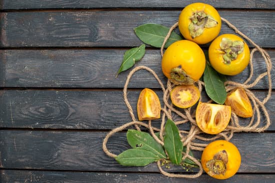 canva sweet persimmons in wooden background MAEQqGEeqsY