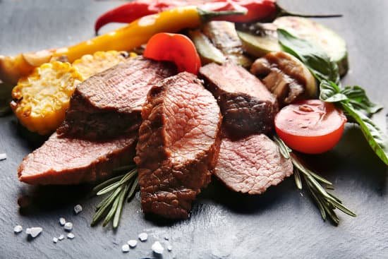 canva tasty juicy meat with vegetables on slate plate MAD9T5ctXI0