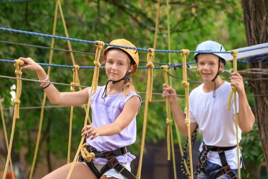 canva two children climbing in adventure park MAD9UG1pFto