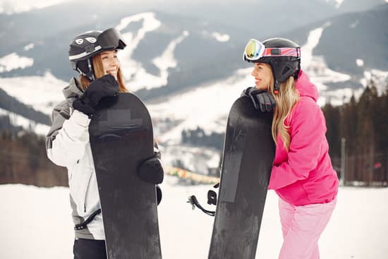 canva two happy women in jacket and helmet with snowboards outdoors MAEWQO WhWU