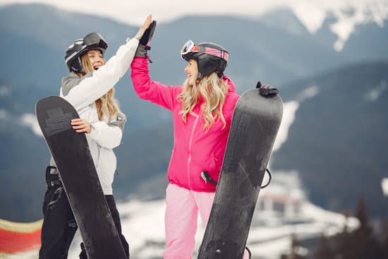 canva two happy women with snowboards doing high five outdoors MAEWQGghF94