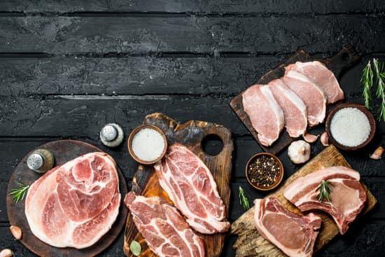 canva variety of pork meat on wooden boards flatlay MAEPnWseeCo