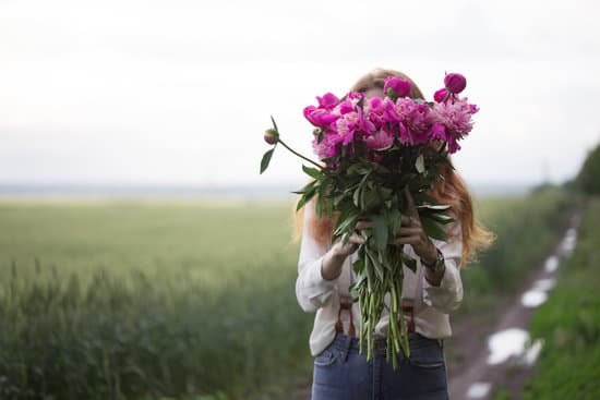 canva woman holding bouquet of peonies outdoors MAD MuEo9i8