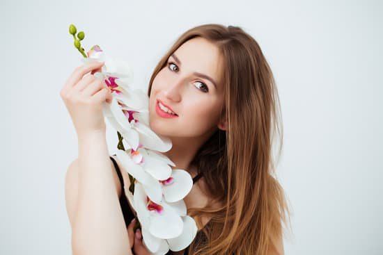 canva woman in bathing suit holding orchid MAEB11fBvLU