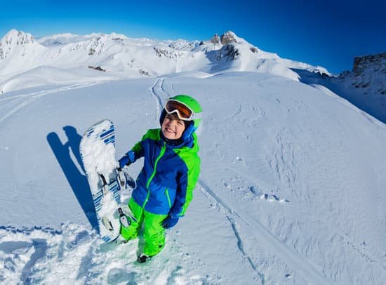 canva young boy holding a snowboard in the mountain slopes MAD gW7Z5TQ