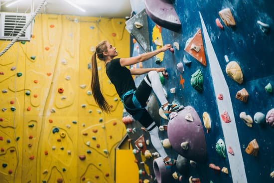 canva young woman climbing a tall indoor man made rock climbing wall MAEBcdmqFHM