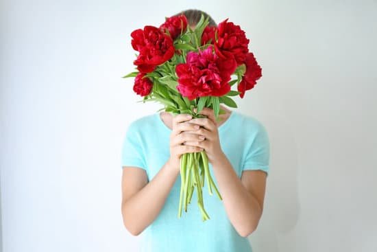 canva young woman holding bunch of peonies on white background MAD9bObqH1U