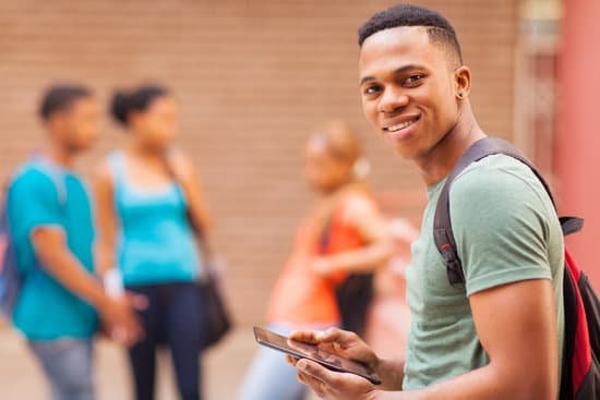 canva african college boy holding tablet computer MADarcmHZQA