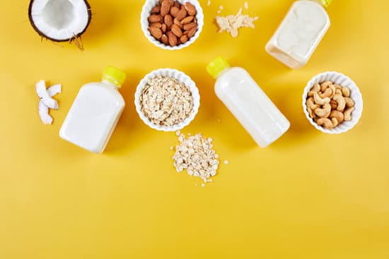 canva alternative types of vegan milks in bottles on a yellow background various vegan plant based milk and ingredients non dairy milk alternative milk flat lay top view with copy space