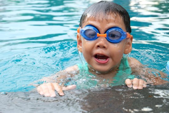 canva asian cute boy splashing on summer pool