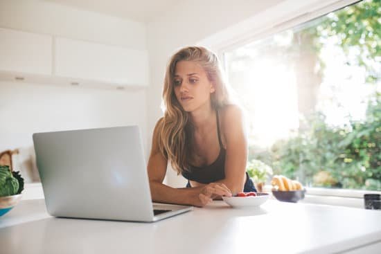 canva beautiful female in kitchen using laptop MADasQ83Krg
