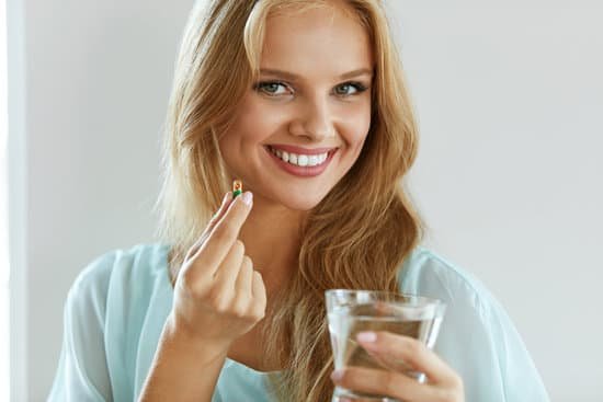 canva beautiful smiling woman taking vitamin pill. dietary supplement MADesHnTJik
