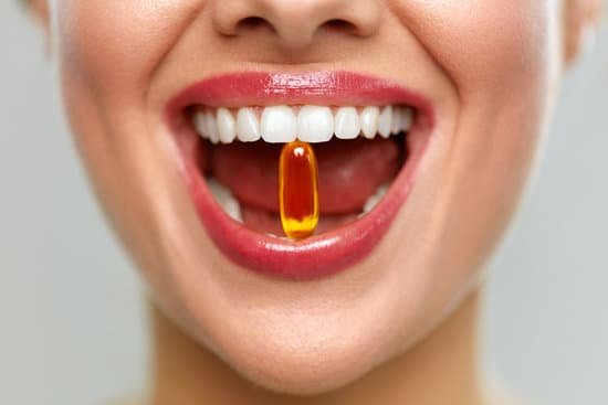 canva beautiful woman mouth with pill in teeth. girl taking vitamins MADauWbR7Vc