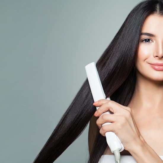 canva beautiful woman with long straight hair using hair straightener. cute smiling girl straightening healthy brown hair with flat iron on gray background MADesI5vLUw