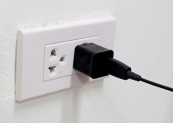 canva black 220 volt power plug in a socket with copyspace MADBdW77o28