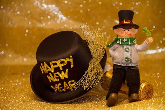 canva black and gold new year hat with irish doll figure MADQ5aKX0XI