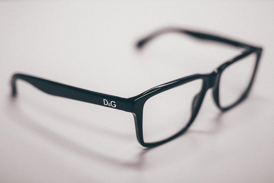canva black dolce gabanna eyeglasses on white surface