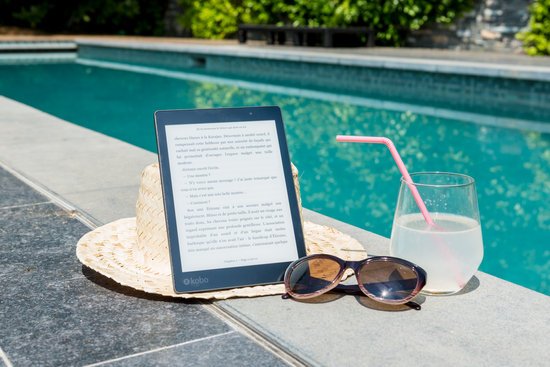 canva black kobo table sunglasses and a glass of juice at pool edge MADGv0TZp1I