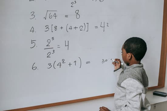 canva black schoolboy solving math examples on whiteboard in classroom MAENv10uqYE