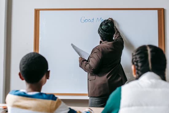canva black teacher writing on whiteboard for diverse pupils MAENvxw Kpc