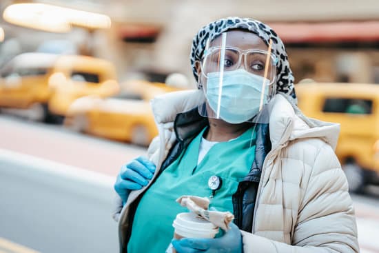 canva calm black nurse in respirator walking on busy street