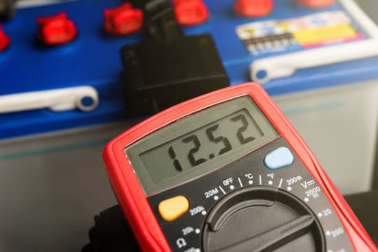 canva checking voltage battery of ca with volt meter 12 v. dc MADSXXLz3c0