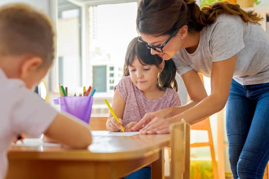 canva children drawing with smiling preschool teacher assisting them MADZ 9IQWVU