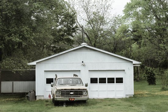 canva classic white chevrolet pickup truck near white 2 door garage near trees MADGyan4PQ4