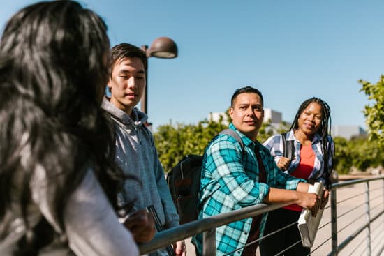 canva college students leaning on a metal railing MAEc lhX nA