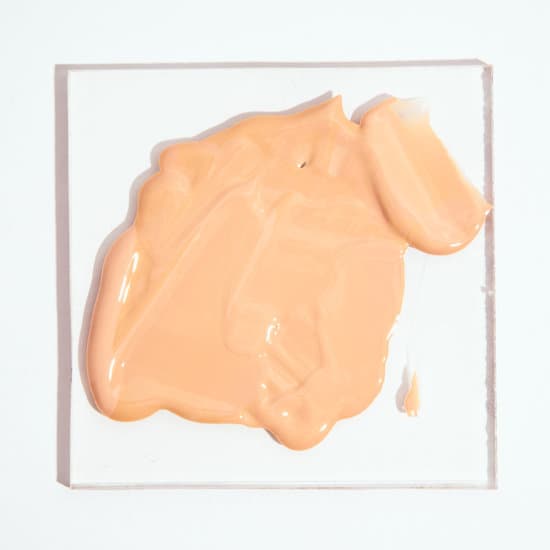 canva creamy liquid makeup foundation smeared on a glass