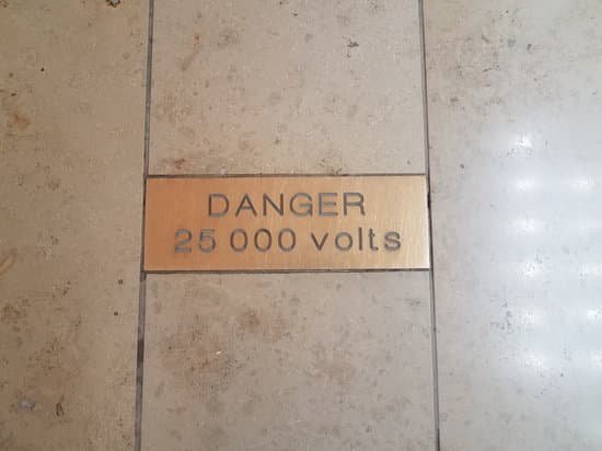 canva danger 25000 volts warning sign on tile floor MADm 2 eOzw