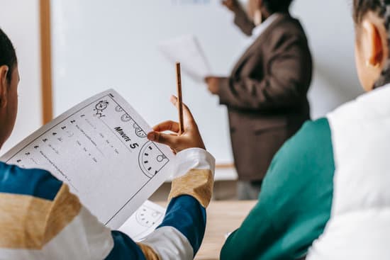 canva diverse crop pupils sitting at desk against black teacher MAENv9mf00A