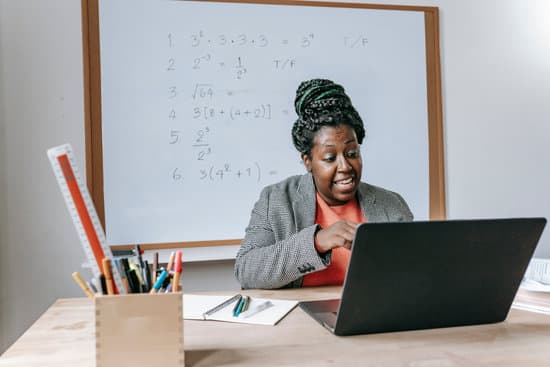 canva excited black teacher explaining mathematics online on laptop MAENv UXbrw