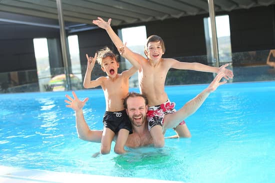 canva father and son enjoying the pool MADQ5iuyKcY
