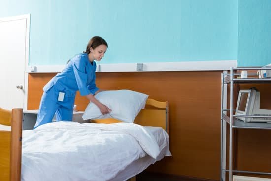 canva female nurse holds a white pillow over the hospital bed in the hospital ward MADatotRhX4