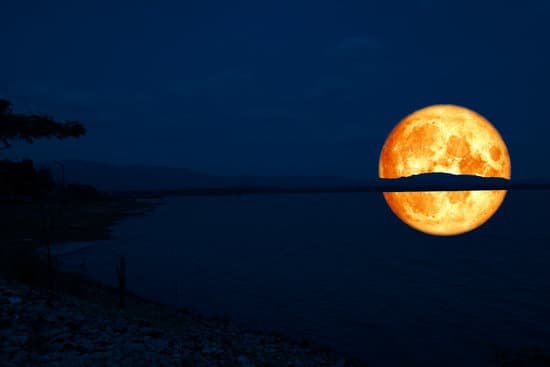 canva full blood moon back on mountain and reflection on lake MADaptVsAXg