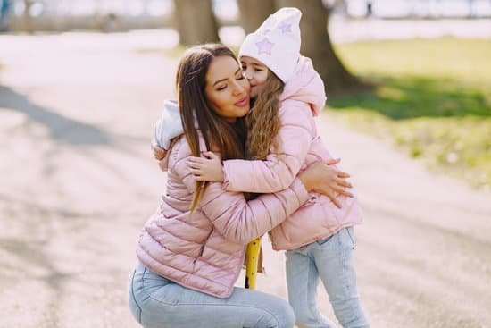 canva girl kissing and hugging mom in park MAD XewrQjM