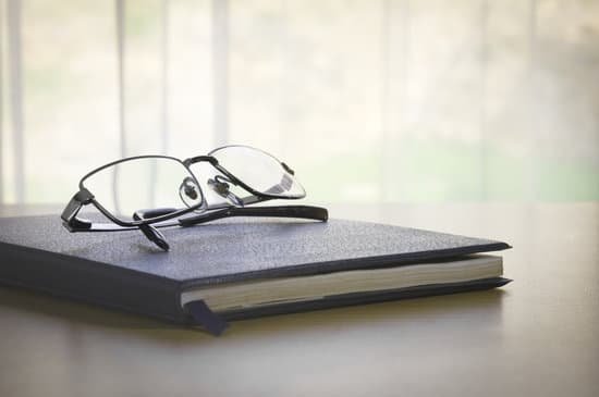 canva glasses on a book MADarcOCDbk