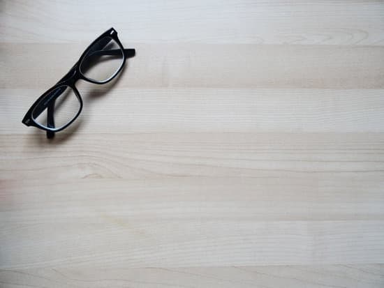 canva glasses on a wooden surface MADQ5LYqJ3M 1