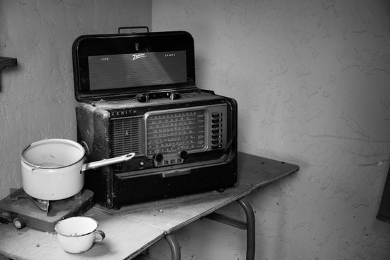 canva grayscale photo of vintage radio beside stove with cooking pot MADGvwn24D0