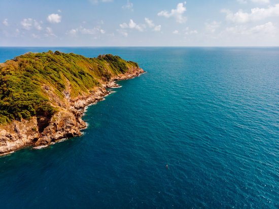 canva green island under cloudy sky