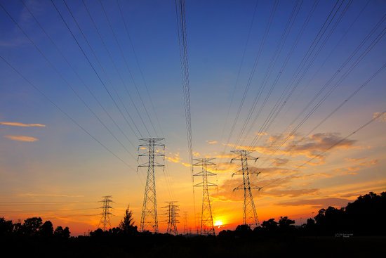 canva grey transmission towers at golden hour