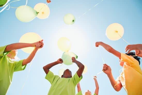 canva group of children holding balloons outdoors MADaAl6j7hw