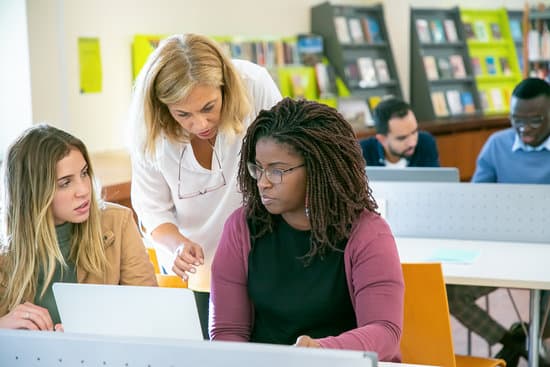 canva group of multiracial students studying in library with teacher MAEOE5wvJwQ