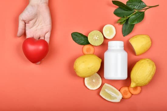 canva hand holding heart next to vitamin pills with fresh fruit MAEKW6 oo0w