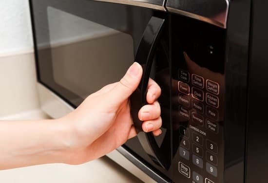 canva hand holding microwave door close up MAC4FCbuEkg