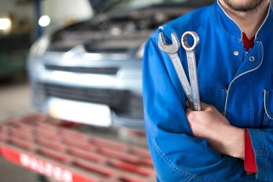 canva hand of car mechanic with wrench. auto repair garage. MADaATZlSE4