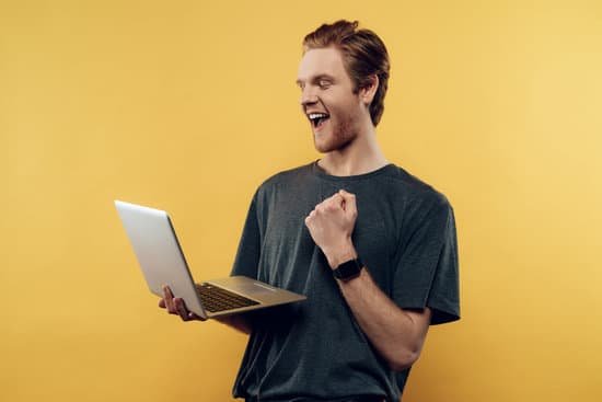 canva happy guy celebrating success using laptop MADesWOYKjM