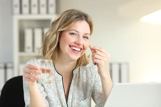 canva happy office worker showing a vitamin supplement pill MADesbLjQec